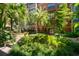 Lush courtyard featuring vibrant greenery, trees, and a serene garden area at 911 N Orange Ave # 447, Orlando, FL 32801