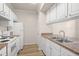 A kitchen view features white appliances and light wood-look floors at 911 N Orange Ave # 447, Orlando, FL 32801