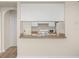 Open concept kitchen with eat-in breakfast bar and white appliances, providing a seamless view into the kitchen at 911 N Orange Ave # 447, Orlando, FL 32801