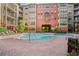 The complex swimming pool is surrounded by lounge chairs and tropical landscaping at 911 N Orange Ave # 447, Orlando, FL 32801