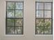 A pair of windows showcase an exterior view through adjustable mini blinds at 911 N Orange Ave # 447, Orlando, FL 32801