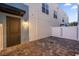 Private back yard with brick pavers, entrance door, and a white privacy fence at 927 City Walk Ln, Oviedo, FL 32765
