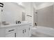 Modern bathroom with white vanity, matte black hardware, and tiled shower-tub combo at 927 City Walk Ln, Oviedo, FL 32765