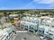 Aerial view of a stylish townhome with a one-bedroom apartment above retail and a lush green landscape at 927 City Walk Ln, Oviedo, FL 32765