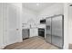 Contemporary white kitchen featuring stainless steel appliances and light wood floors at 927 City Walk Ln, Oviedo, FL 32765