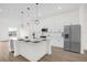 Modern eat-in kitchen features stainless steel appliances and island with breakfast bar at 927 City Walk Ln, Oviedo, FL 32765