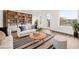 Staged living room featuring built-in shelving, a sofa, and ample natural light at 927 City Walk Ln, Oviedo, FL 32765