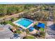 Overhead view of a community pool area featuring a lap pool, playground with sunshades, and nearby palm trees at 927 City Walk Ln, Oviedo, FL 32765