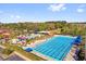 Aerial view of the community pool and water park area with many trees and lounge chairs at 927 City Walk Ln, Oviedo, FL 32765