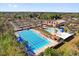 Aerial view of a large swimming pool complex with lap lanes, pool with slide, and a rec center with ample parking at 927 City Walk Ln, Oviedo, FL 32765