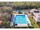 An aerial shot showcasing the community pool with lap lanes, playground, lounge chairs, and lush landscaping at 927 City Walk Ln, Oviedo, FL 32765