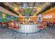 Interior of a stylish pub featuring a round bar, comfortable seating, and warm lighting at 927 City Walk Ln, Oviedo, FL 32765