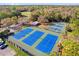 An aerial view of a well-maintained tennis court facility with multiple courts and surrounding greenery at 927 City Walk Ln, Oviedo, FL 32765