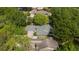 Aerial view of a house nestled among lush greenery, highlighting its roof and surrounding landscape at 106 Waterwood Dr, Yalaha, FL 34797