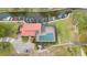 Aerial view showcasing a home with a pool, boat dock, lush landscaping, and waterfront access at 106 Waterwood Dr, Yalaha, FL 34797