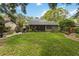 Spacious backyard with a well-manicured lawn and an inviting outdoor dining area at 106 Waterwood Dr, Yalaha, FL 34797