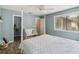 Tranquil bedroom features a comfortable seating area, wood flooring, and a large window at 106 Waterwood Dr, Yalaha, FL 34797