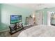 Bright bedroom features a TV, dresser, and en suite bathroom access at 106 Waterwood Dr, Yalaha, FL 34797