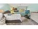 Comfortable bedroom with a large window, ceiling fan, and neatly arranged furniture at 106 Waterwood Dr, Yalaha, FL 34797