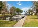 Scenic view of a boat dock with several boats moored in the canal, surrounded by green lawns and trees at 106 Waterwood Dr, Yalaha, FL 34797