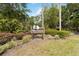 Waterwood community sign surrounded by lush greenery and mature trees offering a scenic entrance at 106 Waterwood Dr, Yalaha, FL 34797