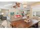 Dining area view highlighting access to living room, kitchen, and screened-in lanai with vaulted ceilings at 106 Waterwood Dr, Yalaha, FL 34797