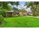 Attractive single-story home with a lush green lawn, mature trees and a well-maintained landscape at 106 Waterwood Dr, Yalaha, FL 34797