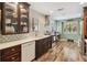 Bright kitchen featuring stainless steel appliances, tile backsplash, and wood flooring at 106 Waterwood Dr, Yalaha, FL 34797