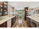 Modern kitchen with ample counter space, wood floors, stainless steel appliances, and decorative backsplash at 106 Waterwood Dr, Yalaha, FL 34797