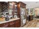 Charming kitchen offers updated stainless steel appliances, plenty of storage, and island with breakfast bar at 106 Waterwood Dr, Yalaha, FL 34797