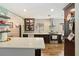 Well-appointed kitchen with a functional layout, modern appliances, white countertops, and floating shelves at 106 Waterwood Dr, Yalaha, FL 34797