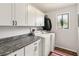 Well-organized laundry room with modern appliances, ample cabinet space, and a window at 106 Waterwood Dr, Yalaha, FL 34797