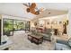 Spacious living room showcases vaulted ceilings, modern ceiling fans, and easy access to the screened-in lanai at 106 Waterwood Dr, Yalaha, FL 34797