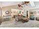 Inviting living room with open floor plan leading to dining area and featuring a ceiling fan and skylight at 106 Waterwood Dr, Yalaha, FL 34797