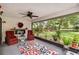 Inviting screened porch with comfortable seating, a fireplace, and a view of the lush backyard at 106 Waterwood Dr, Yalaha, FL 34797