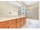 Bathroom featuring single sink vanity, updated lighting, and shower-tub combo at 1072 Weaver Dr, Oviedo, FL 32765