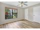 Bedroom with wood floors and a large window for natural light at 1072 Weaver Dr, Oviedo, FL 32765