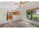Bright dining area featuring wood-look laminate floors and natural light from a large window at 1072 Weaver Dr, Oviedo, FL 32765