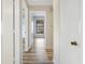 Hallway with wood floors and views into the bedrooms at 1072 Weaver Dr, Oviedo, FL 32765