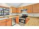 Functional kitchen with light wood cabinets, laminate countertops, and stainless steel appliances at 1072 Weaver Dr, Oviedo, FL 32765