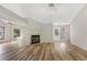 Spacious living room with wood-look laminate floors, fireplace, and plenty of natural light at 1072 Weaver Dr, Oviedo, FL 32765