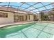 A screened in pool area and a house with sliding glass doors that lead to the lanai at 1072 Weaver Dr, Oviedo, FL 32765