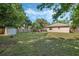 Expansive backyard featuring a shed, wood fence, mature trees and lawn at 1101 S Thompson Ave, Deland, FL 32720