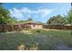 Fenced backyard with trees and grass at 1101 S Thompson Ave, Deland, FL 32720