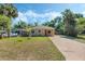 Charming single-story home featuring a well-maintained lawn and a long driveway at 1101 S Thompson Ave, Deland, FL 32720