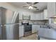 Well-lit kitchen featuring stainless steel appliances, white cabinets, and stylish backsplash at 1101 S Thompson Ave, Deland, FL 32720