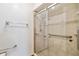 Tiled walk-in shower featuring safety bars in renovated bathroom at 1117 Indiana Ave, St Cloud, FL 34769