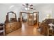 Bedroom with wood floors, ceiling fan, dresser, and view to dining room and bathroom at 1117 Indiana Ave, St Cloud, FL 34769