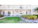 Inviting two-story condo with a white exterior, balcony, and well-maintained landscaping at 1140 S Orlando Ave # F-3, Maitland, FL 32751