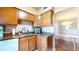 Kitchen featuring granite counters, wooden cabinets, and stainless steel appliances at 1140 S Orlando Ave # F-3, Maitland, FL 32751